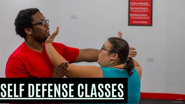 Short female hand thrusting underneath attacker's chin in a self-defense class.
